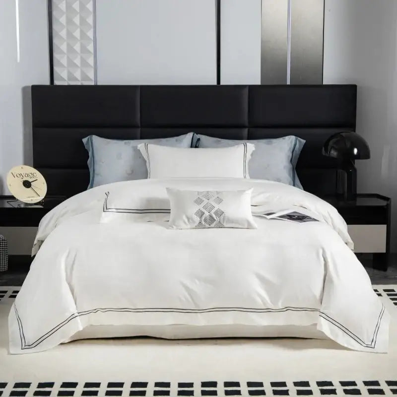 White satin duvet cover with black piping and an embroidered pillow in beige and gold decorbites butterfly jacquard lyocell cotton bedding set