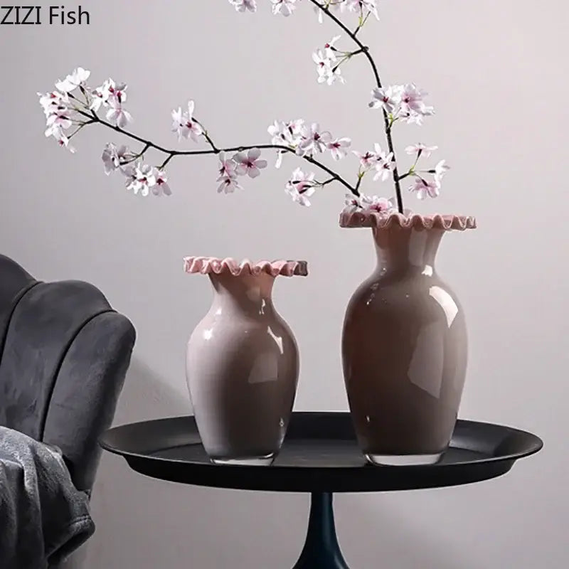 Two elegant beige ceramic vases with glossy finish and pink flower edge rims on a black tray for living room decor