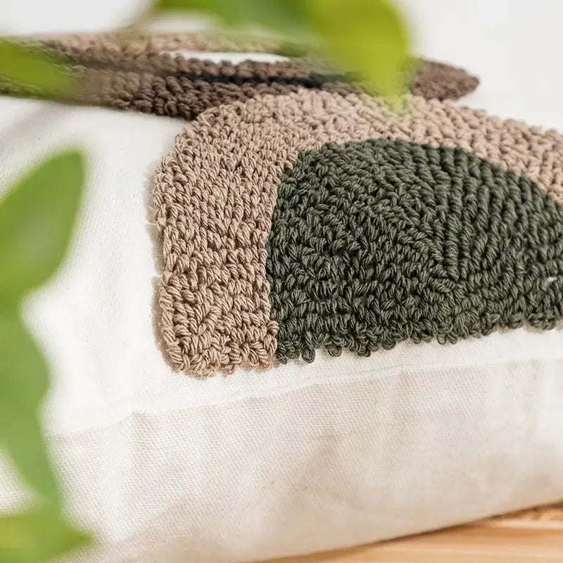 Beige and white geometric embroidery tassel cushion cover with cozy hand-crocheted patchwork in earthy tones for decorbites decor