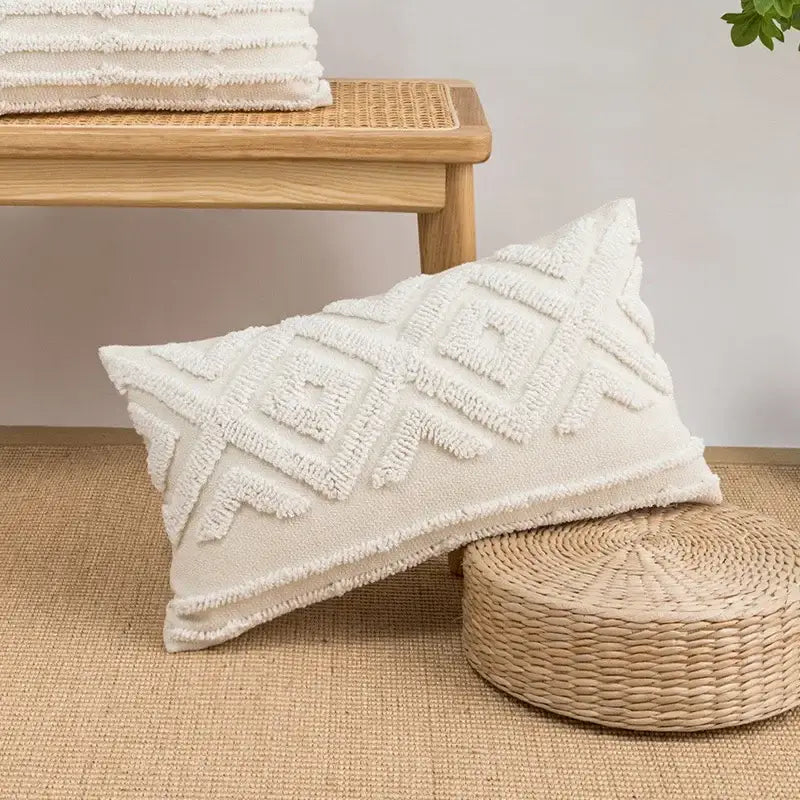 Cream-colored cushion cover with decorbites geometric embroidery tassel and textured frayed edges for living room decor
