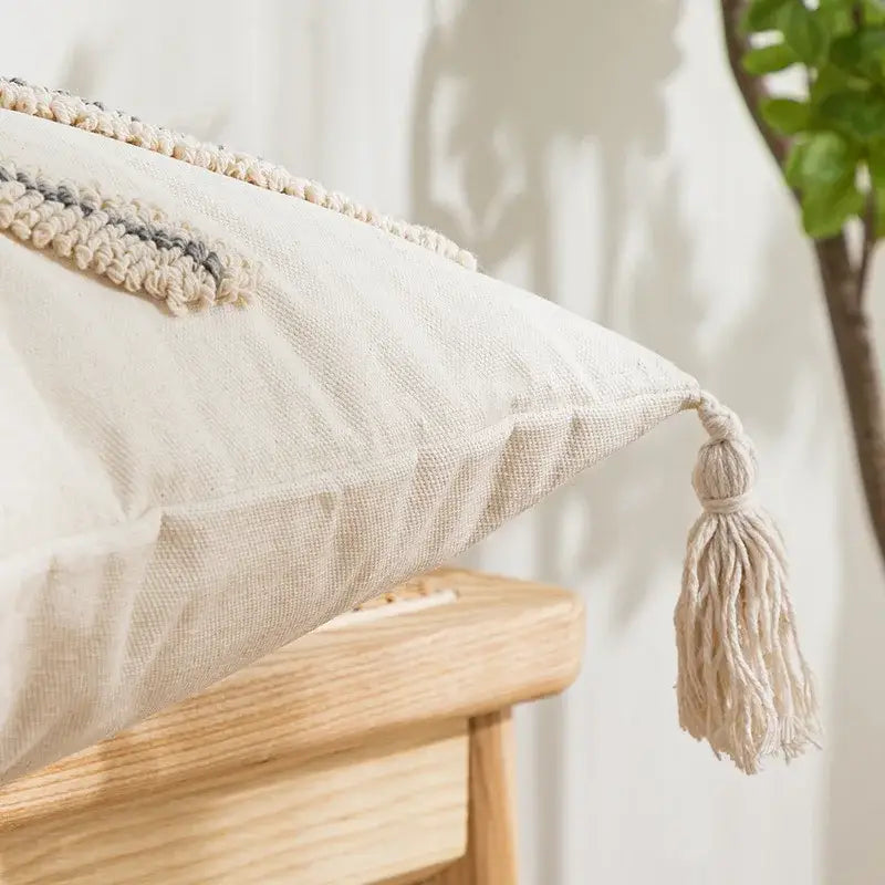 Beige linen cushion cover with textured woven stripe and matching tassel decorbites geometric embroidery tassel design
