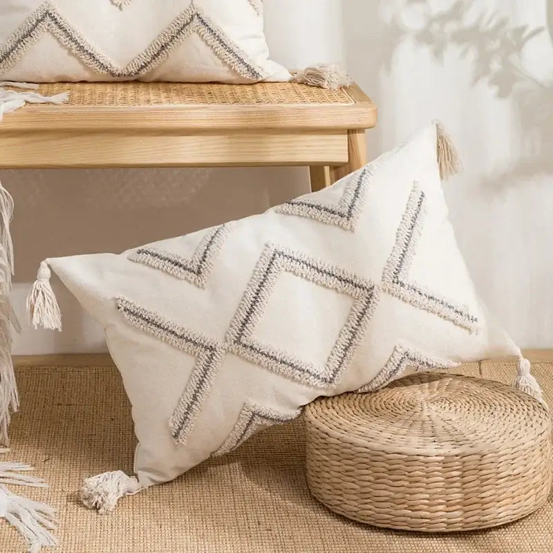 Beige and white cushion cover with decorbites geometric embroidery and tassels, ideal for living room decor