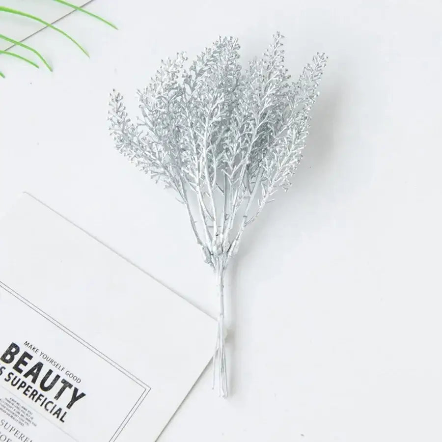 A delicate silver metallic artificial plant arrangement with intricate feathery branches for decorbites golden wheat decor