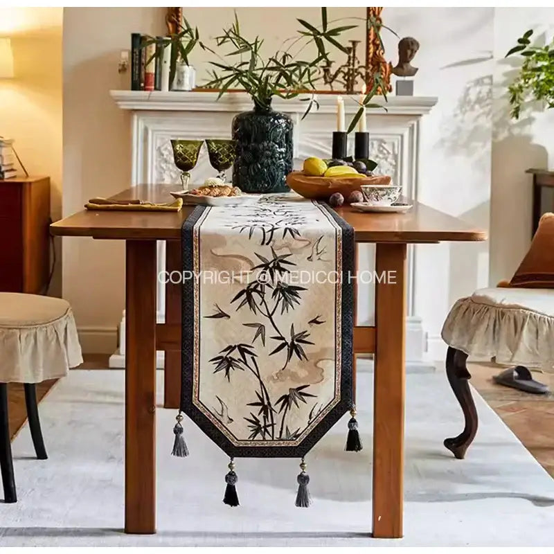 Beige table runner with black bamboo leaf and swallow print embroidery bordered in dark blue decorbites bamboo leaf design