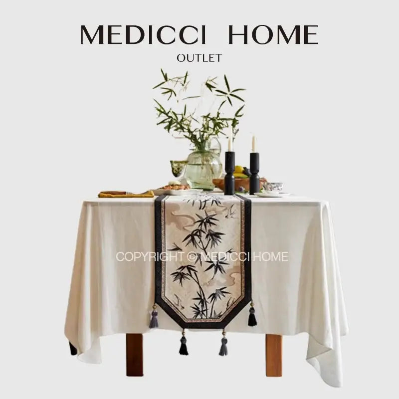 Beige bamboo leaf swallow print table runner with embroidered design and black tassels for dining room decor by decorbites