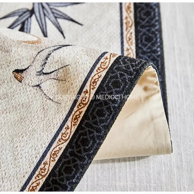 Beige table runner with swallow print featuring decorbites bamboo leaf design and embroidered linen pillow with velvet trim