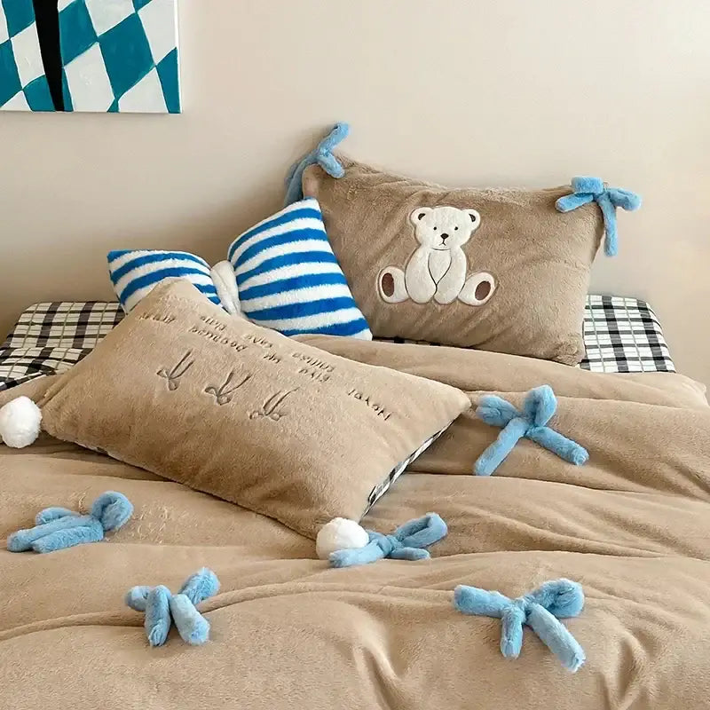 Beige and blue embroidered velvet duvet bedding set with tan plush bed set featuring teddy bear pillow and blue bow accents