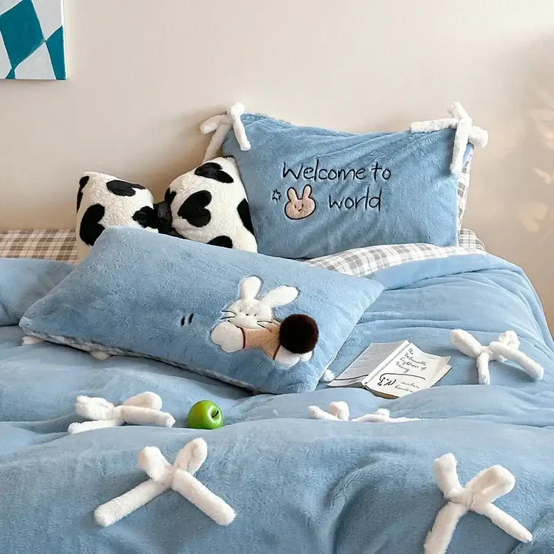 Blue plush bedding set featuring embroidered bunny and welcome to world design in beige and blue velvet duvet bedding