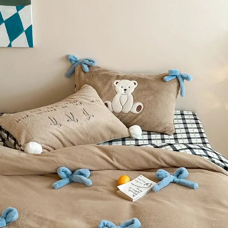 Beige plush pillow with embroidered white teddy bear and blue bow ties in velvet duvet bedding set bedroom decor