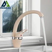 Beige brass kitchen faucet with speckled ceramic finish 360 swivel spout and polished chrome accents for modern kitchens