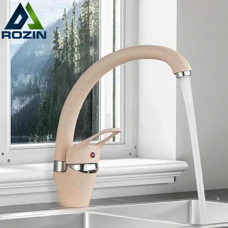 Beige brass kitchen faucet with speckled ceramic finish 360 swivel spout and polished chrome accents for modern kitchens