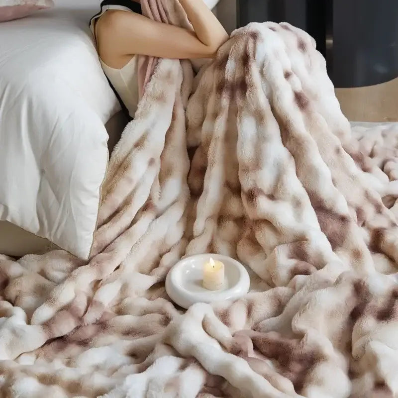 A beige and brown faux fur decorbites cozy fleece throw blanket with a soft mottled pattern for bedroom use