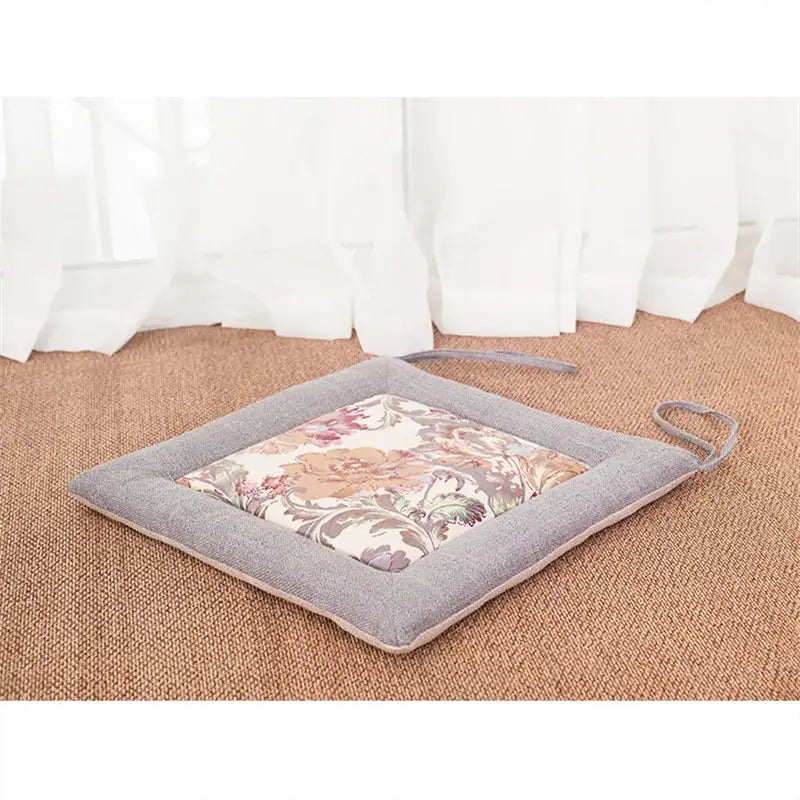 Beige and brown non-slip decorbites linen seat cushion with gray border and pastel embroidered floral pattern for dining chair