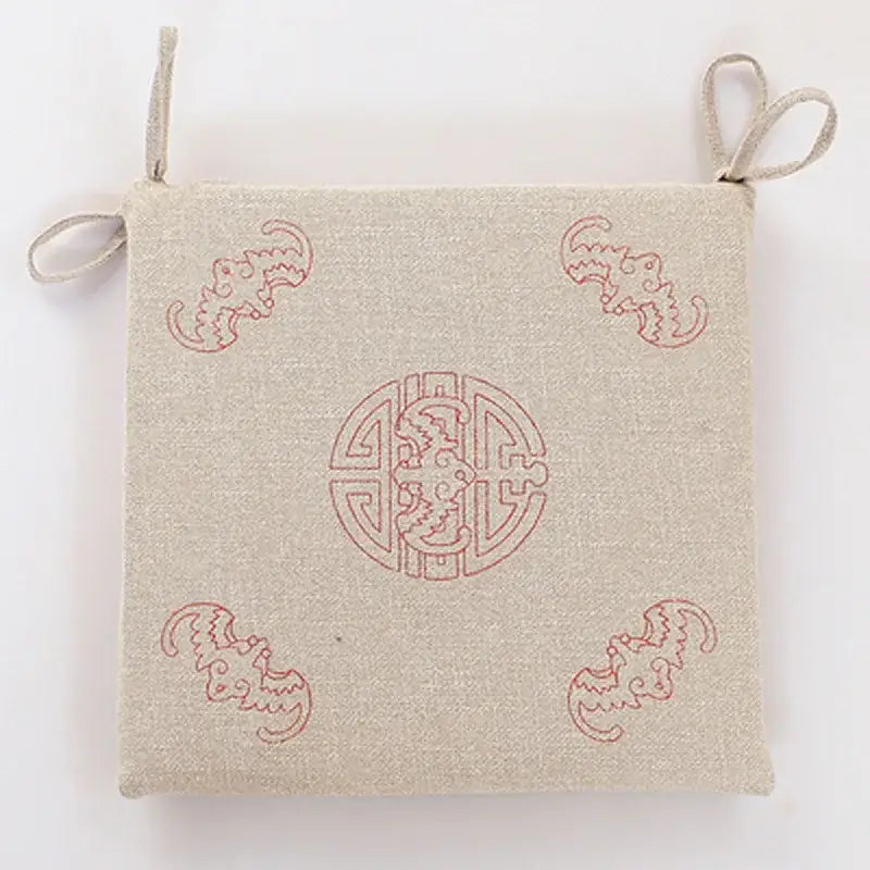 Beige and brown non-slip linen seat cushion with red embroidered dragon motifs and central circular design decorbites linen seat