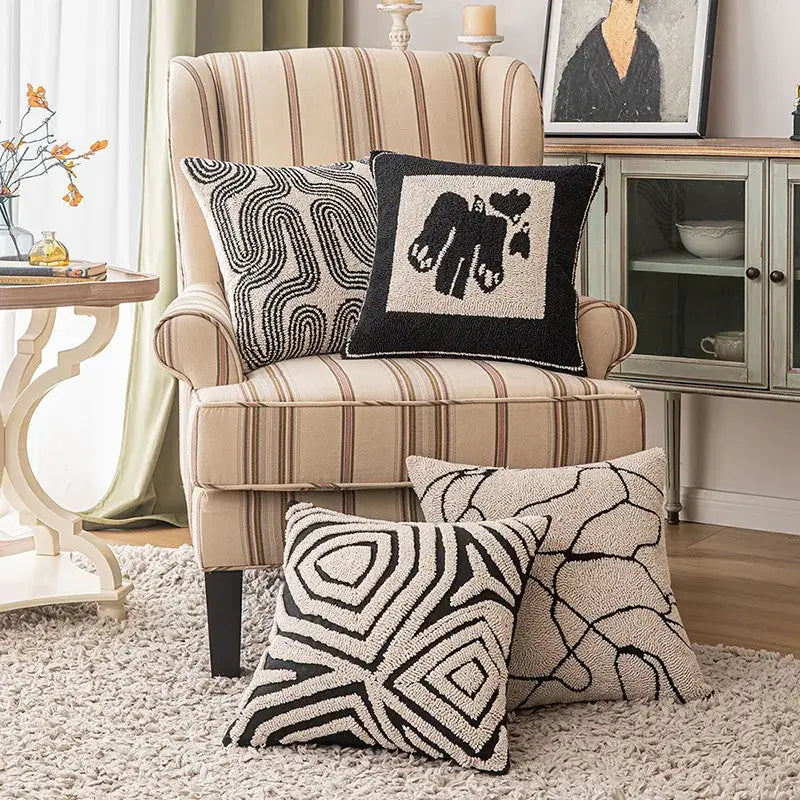 Beige and brown striped wingback armchair with black and beige decorbites geometric line art cushion cover pillows