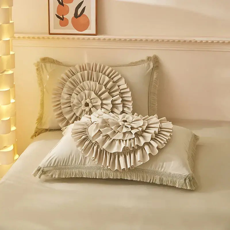 Cream-colored ruffled pillow with fringed edges and central floral embellishment from decorbites brushed cotton bedding set