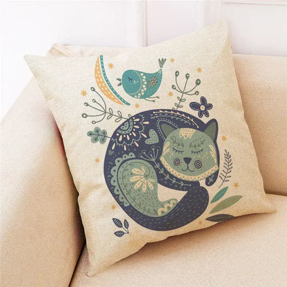 Beige cartoon cat linen throw pillow featuring a whimsical sleeping green cat with foliage and teal bird decorbites cartoon cat