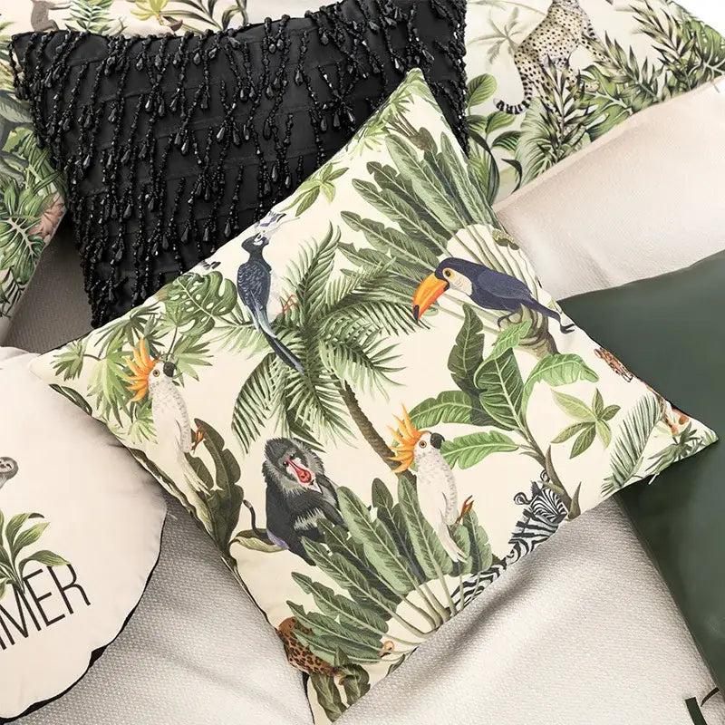 Beige velvet cushion cover featuring a vibrant decorbites jungle cartoon print with toucans monkeys and zebras