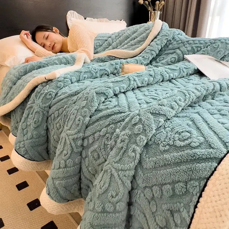 A plush teal fleece warmth blanket with a raised geometric floral pattern and cream inner lining for decorbites carved velvet