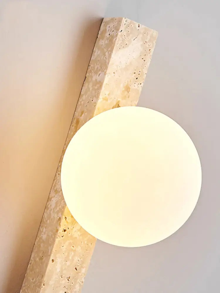 Modern beige cave stone wall lamp with dual glass sconce featuring a circular frosted shade for stylish wall decorbites cave stone lighting