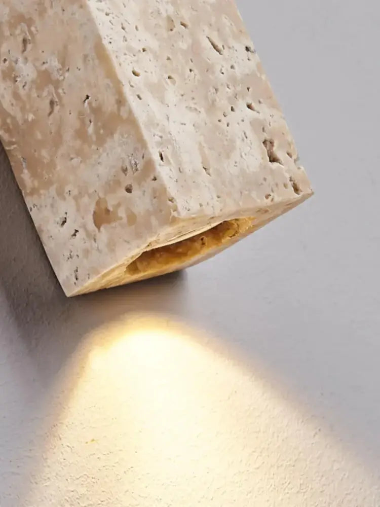 Beige cave stone wall lamp with textured natural surface and warm golden light for living room decorbites cave stone wall lamp