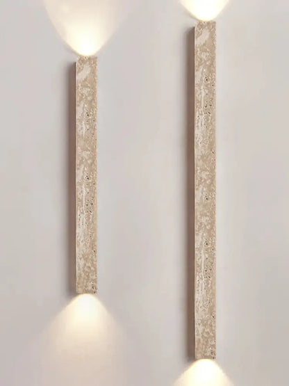 Two beige decorbites cave stone wall lamps with speckled finish emit warm light in living room dual glass sconce design