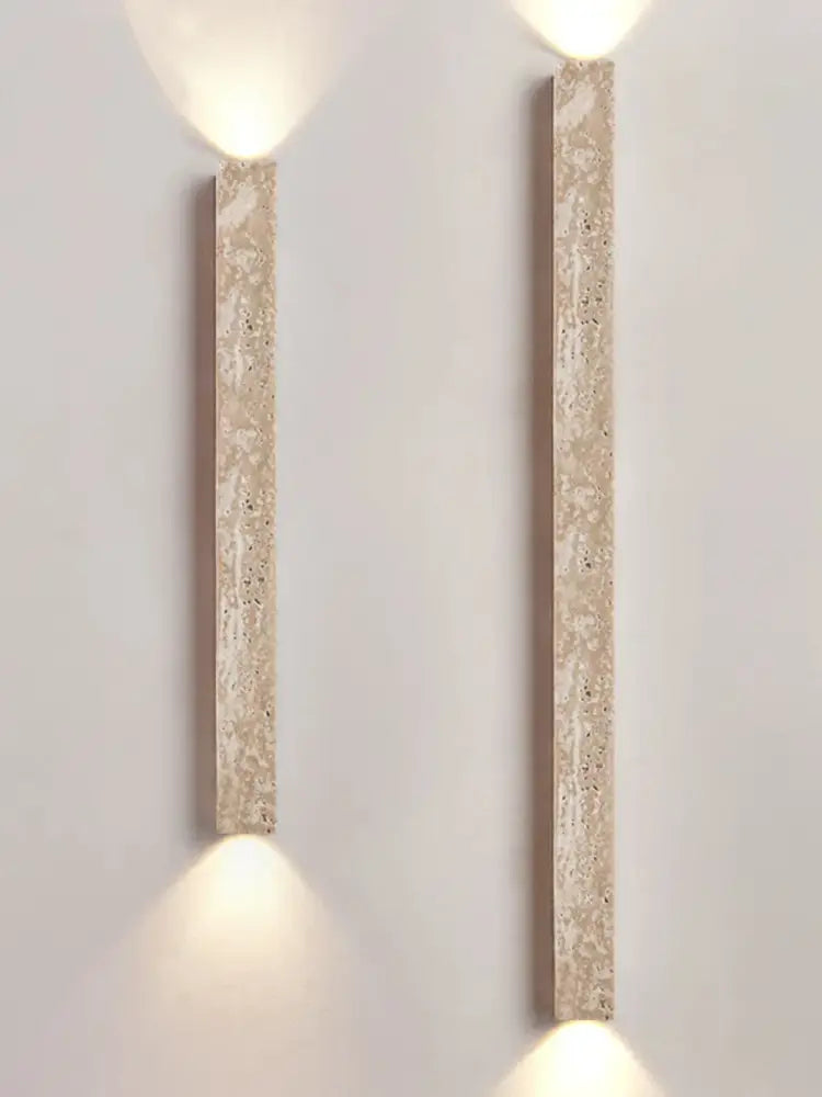 Two beige decorbites cave stone wall lamps with speckled finish emit warm light in living room dual glass sconce design
