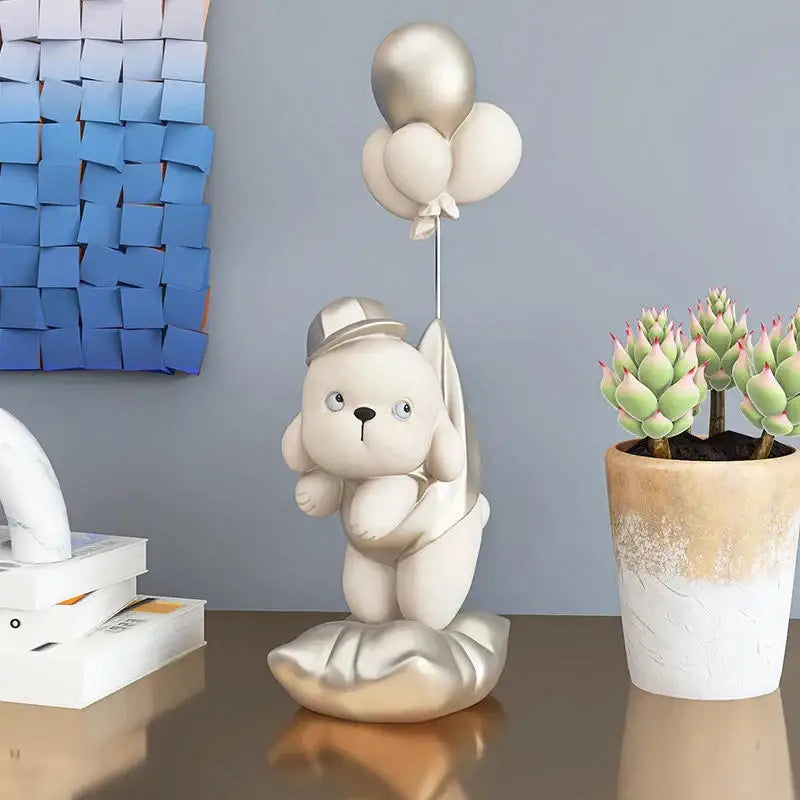 Beige ceramic balloon puppy statue featuring a cream-colored figurine of a puppy wearing a cap and holding balloons