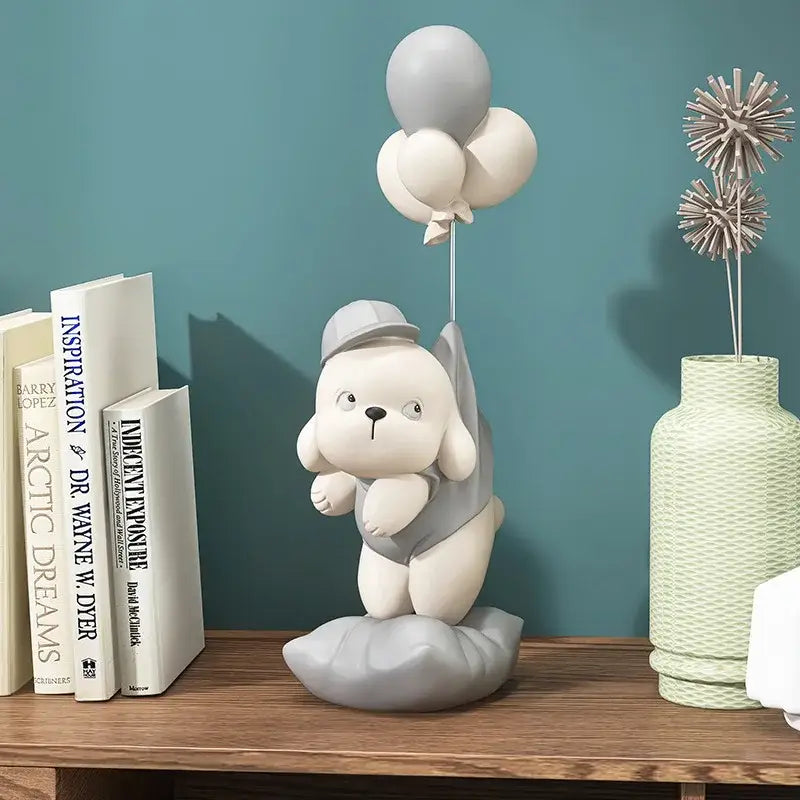 Beige ceramic balloon puppy statue featuring a cute white puppy figurine with a gray hat holding balloons for decor