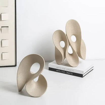 Beige ceramic coral hollow sculpture with flowing intertwined forms and circular cutouts for living room decorbites coral hollow decor
