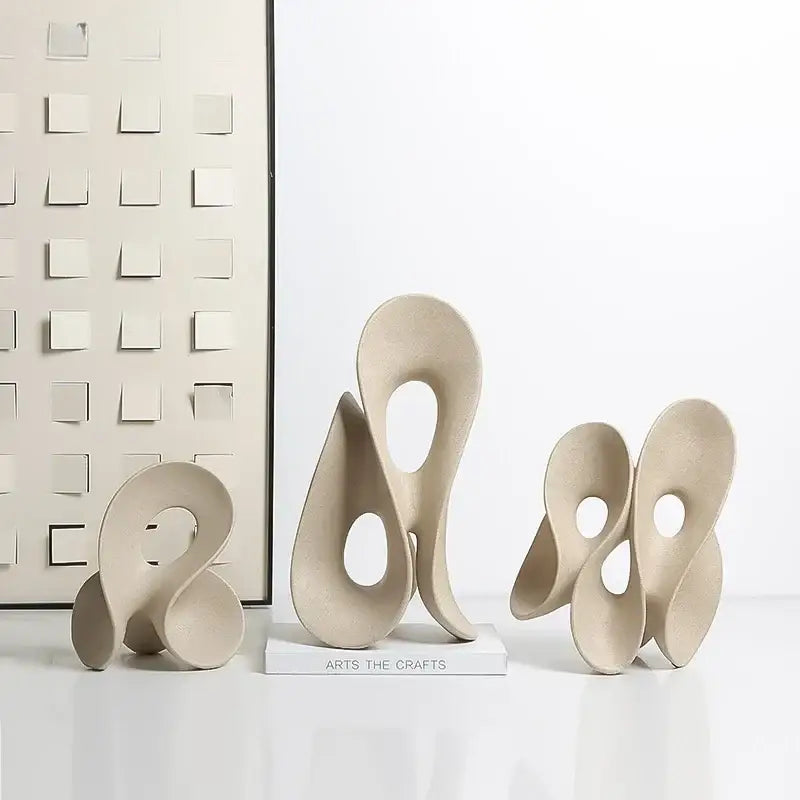 Beige ceramic coral hollow sculpture with smooth flowing forms and circular cutouts for living room decorbites coral hollow