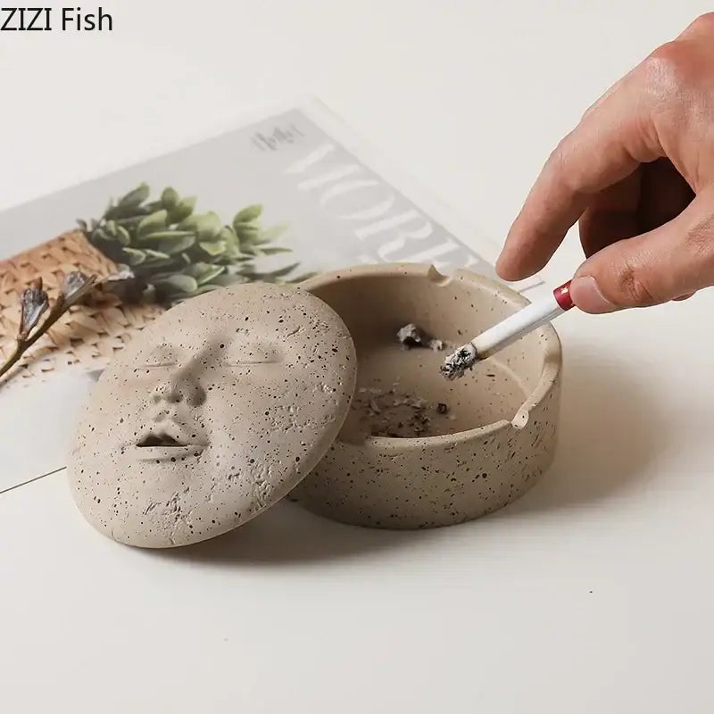 Beige ceramic human face character ashtray with lid featuring a serene face design ideal for office decor