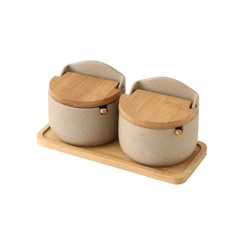 Beige ceramic seasoning jar set with bamboo lids on wooden trays ideal for kitchen use by decorbites ceramic seasoning