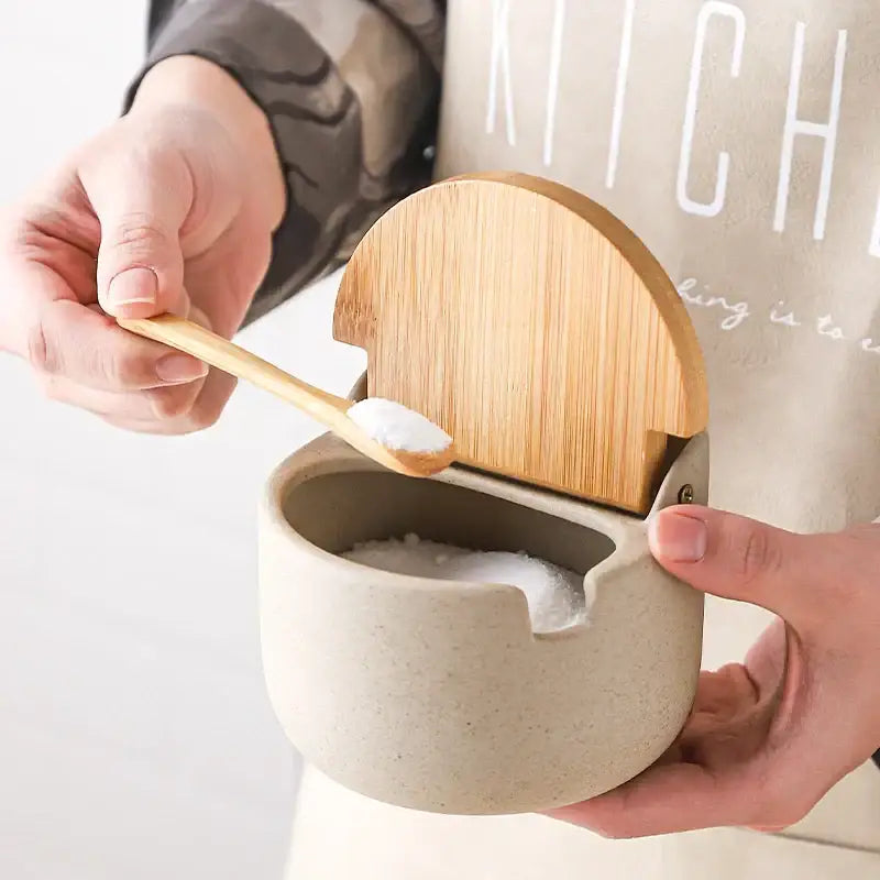 Beige decorbites ceramic seasoning jar set with bamboo lid and matching wooden spoon for kitchen use
