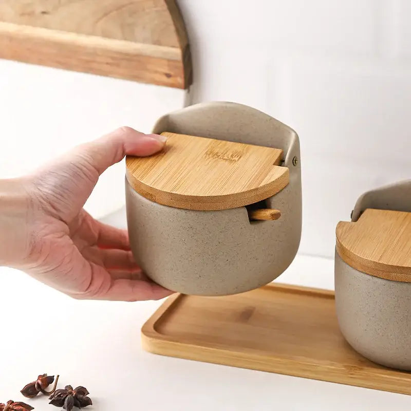 Beige ceramic seasoning jar set by decorbites with bamboo lid and integrated wooden spoon for kitchen use