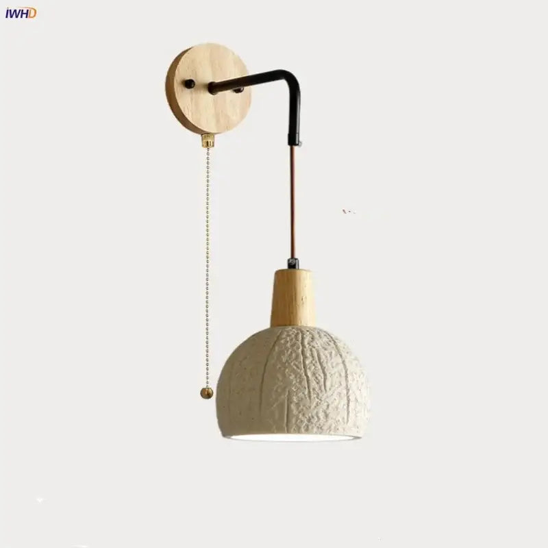 Beige ceramic wall sconce with textured pendant lamp, wooden mount, black arm, and pull chain switch for bedroom