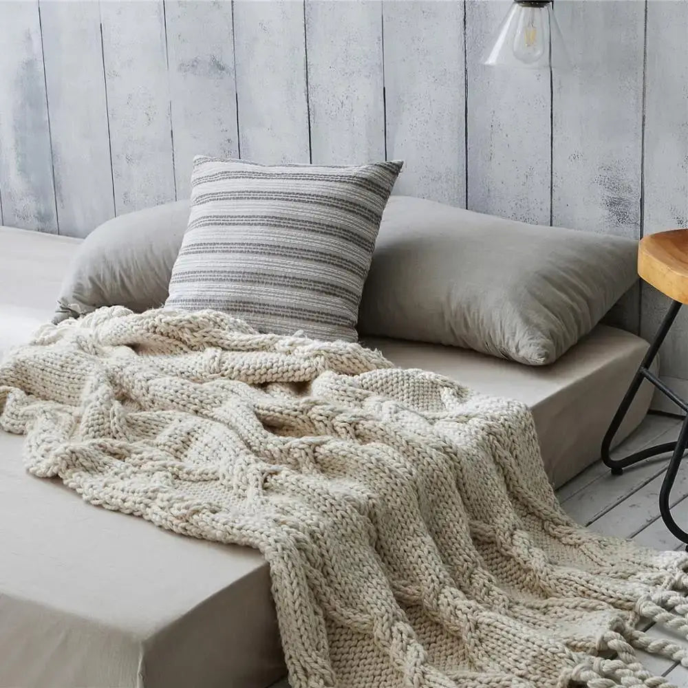 Beige chunky knit tassel blanket with cream-colored braided cable pattern and tassels for soft bedroom decorbites decor