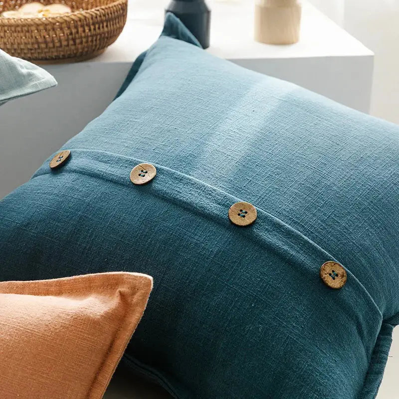 Teal cotton linen cushion cover with natural wood buttons along stitched seam for decorbites living room decor