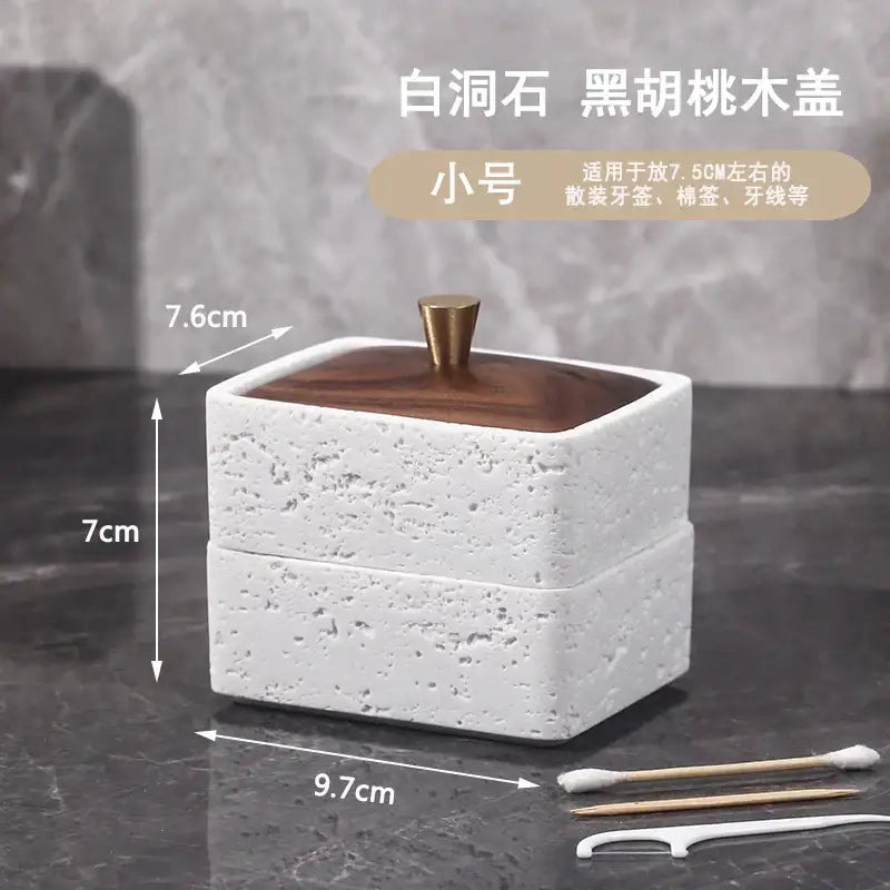 Beige and dark wood double decker natural stone jewelry organizer with white textured ceramic toothbrush holder and brass knob lid