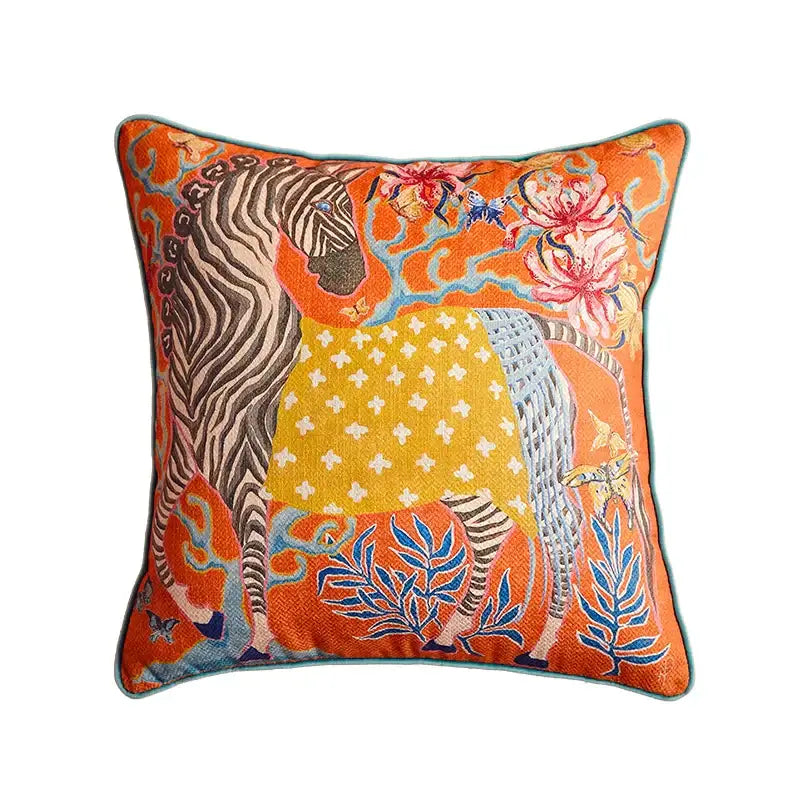 Beige pillow case with vibrant orange embroidered zebra and floral motifs complementing egret bird pattern art for sofa