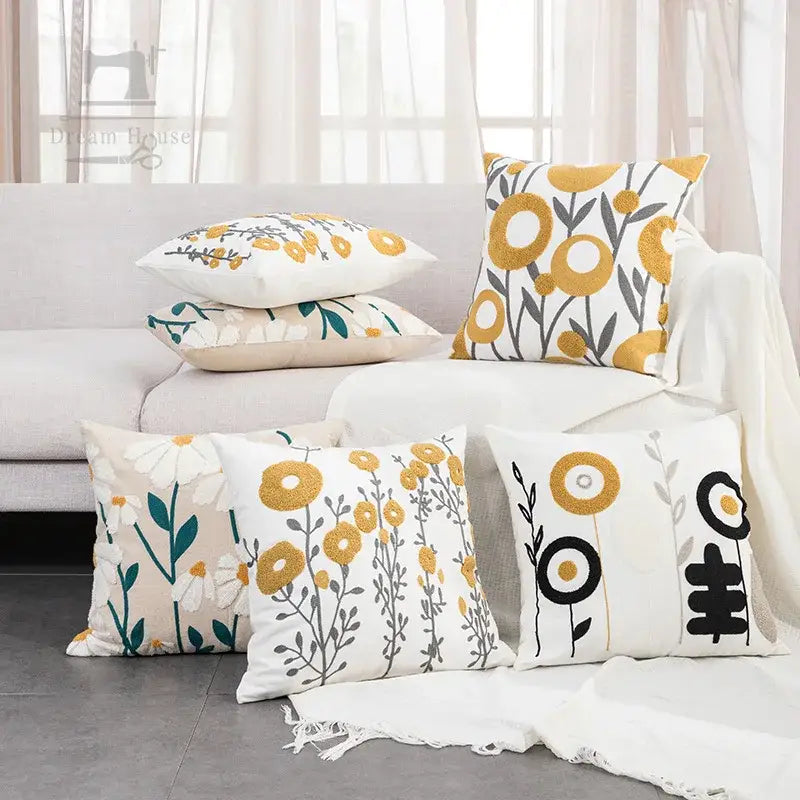 Beige embroidered daisy floral pillow cover with yellow black green botanical patterns on soft fabric for bedroom decor