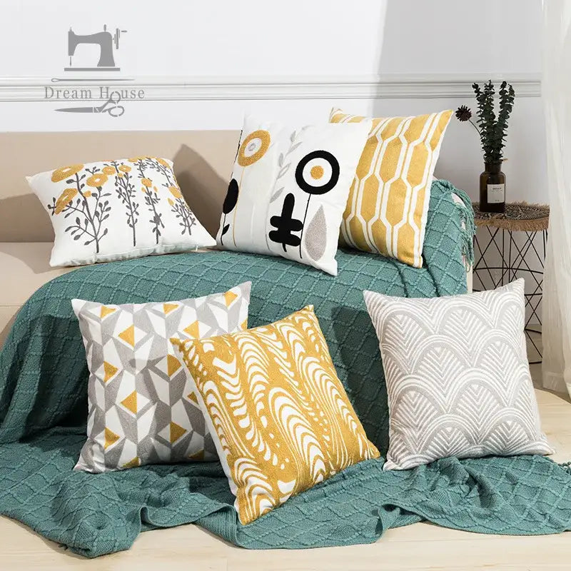 Set of six decorative throw pillows in yellow white gray and teal featuring embroidered daisy floral and geometric patterns pillow cover