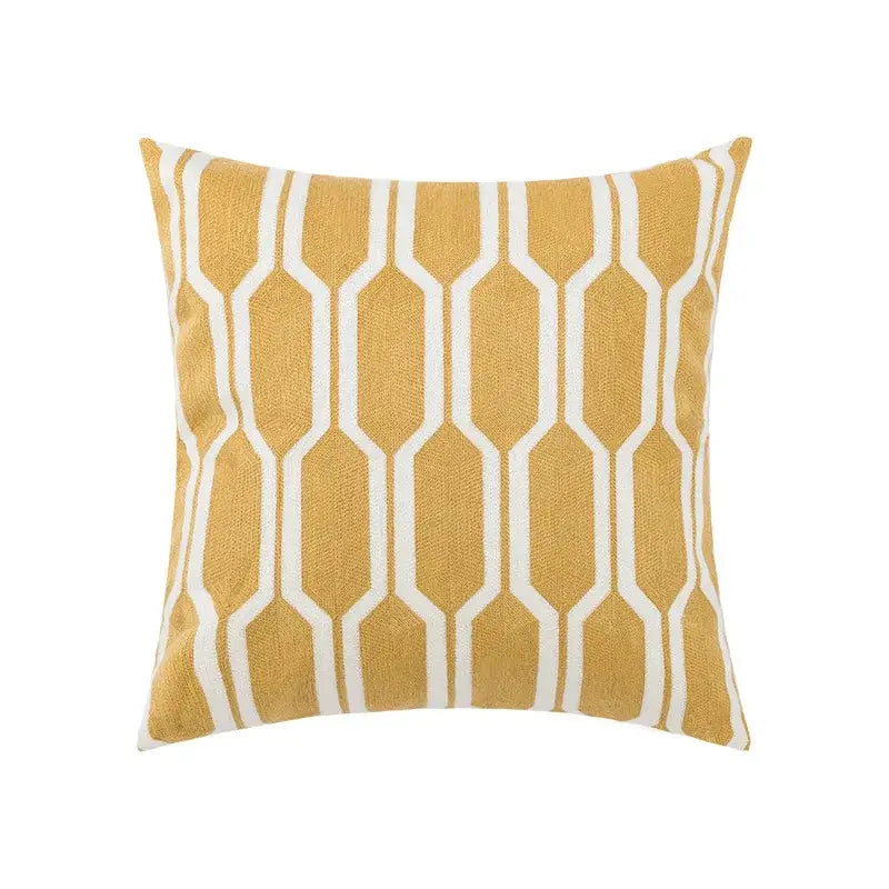 Square throw pillow cover with mustard yellow base and white geometric patterns, featuring embroidered daisy floral design