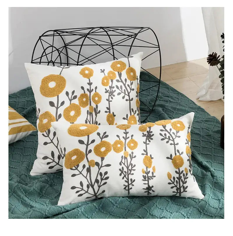 Beige pillow cover with embroidered daisy floral design in yellow and gray for elegant bedroom decor