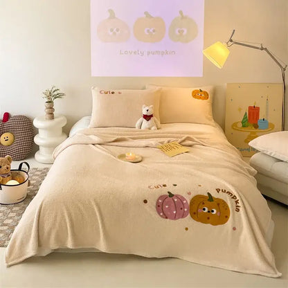 Beige embroidered teddy fleece blanket featuring cream plush fabric with cartoon pumpkins and cozy teddy fleece design