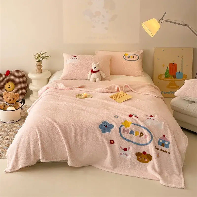 Beige cozy teddy fleece blanket with pink plush side embroidered cartoon characters and happy in blue oval decorbites cozy teddy