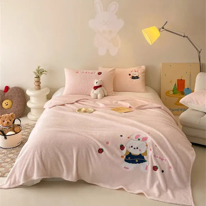 Beige embroidered teddy fleece blanket with pink plush fabric featuring a rabbit holding strawberries for cozy teddy fleece decorbites