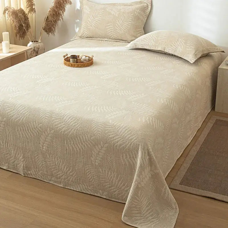Beige cotton linen bed sheet set with a subtle raised fern leaf pattern ideal for bedroom bedding
