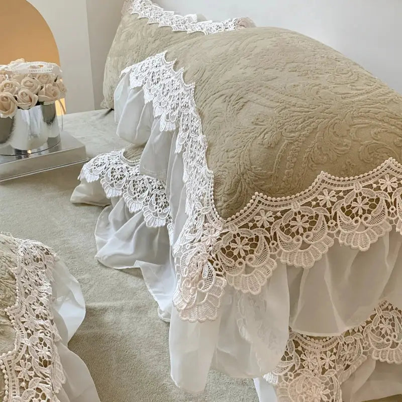 A delicate ivory lace pillow cover with french lace ruffles draped over a beige cushion from decorbites bedding set