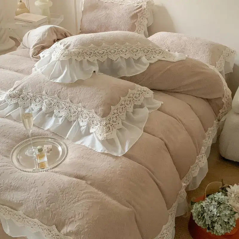 A delicate ivory lace-trimmed pillow sham with french lace ruffles rests on a plush beige bedding set decorbites velvet bedspread
